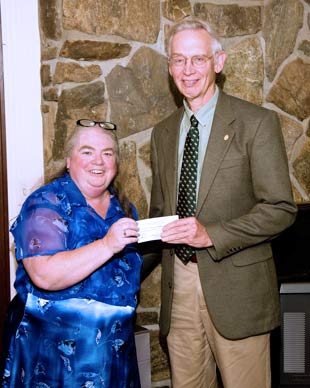 President Cindy Mitchell presents Dr. John P. Sauter a $5,000 check to support the expansion of the LRH birthing center.